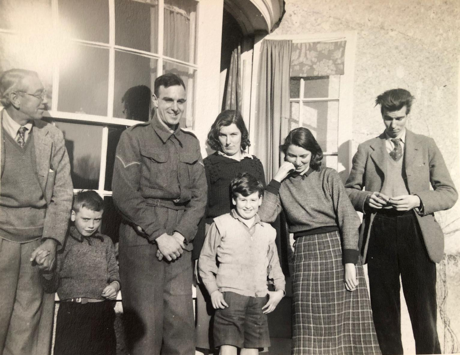 Group of people standing in front of a window and open door