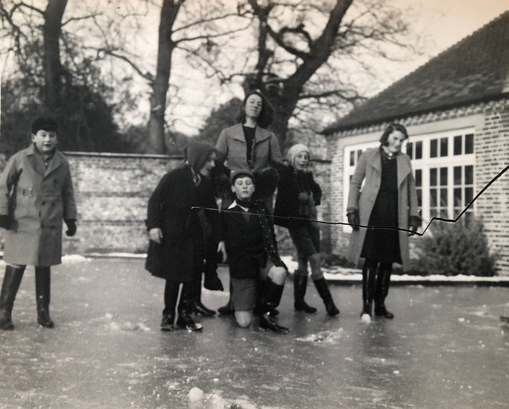Children playing on a frozen swimming pool