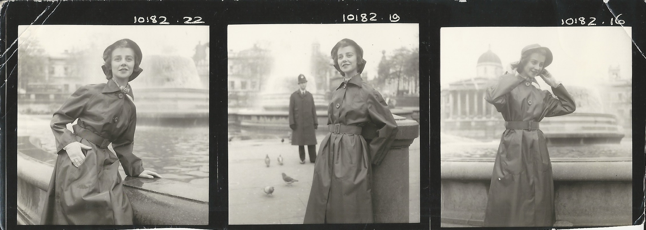 Young woman wearing raincoat and hat in front of fountain in Trafalgar Square, London