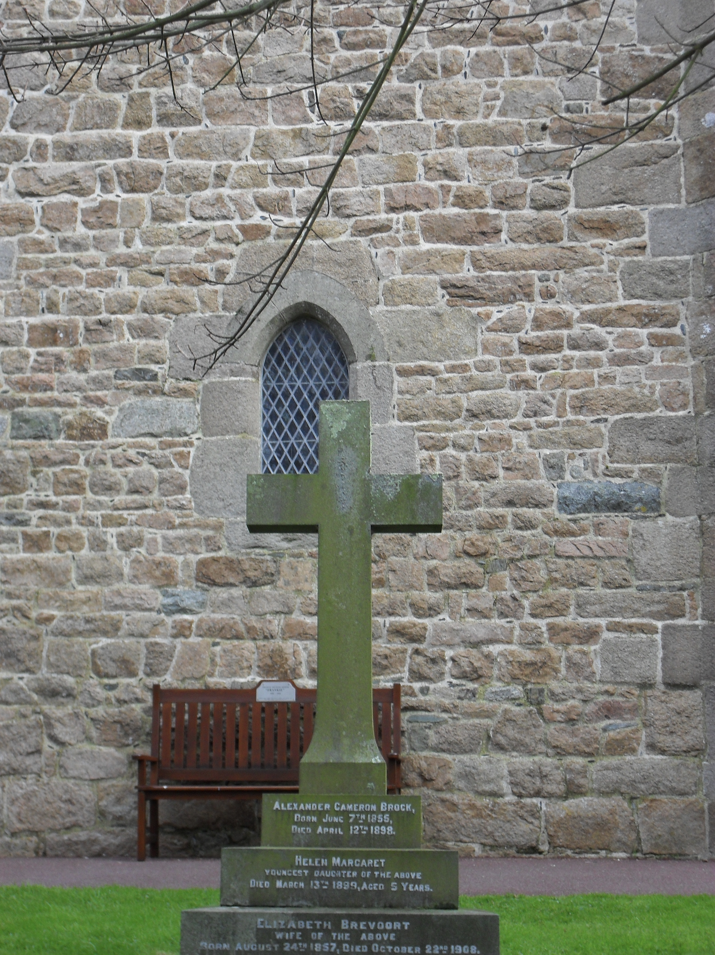Back of a stone cross outside a country church