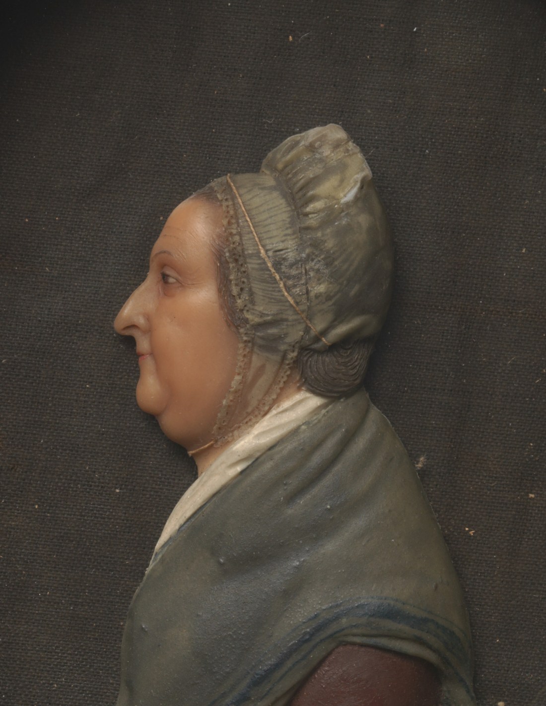 Pigmented wax and oil paint on glass of Margaret Todd Whetten showing an elderly lady in bonnet and shawl in profile