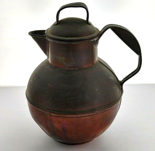 Colour photograph of a heavily tarnished Guernsey Can