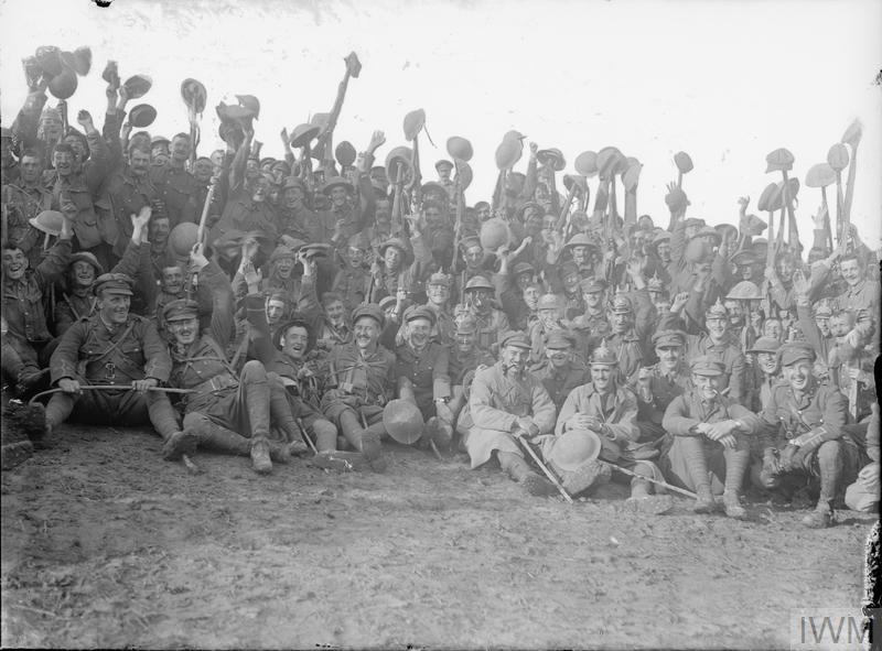 Black and white photo of troops of the 1/5th Battalion, Northumberland Fusiliers cheering after the attack on Le Sars, Nr Albert, 7 October 1916.