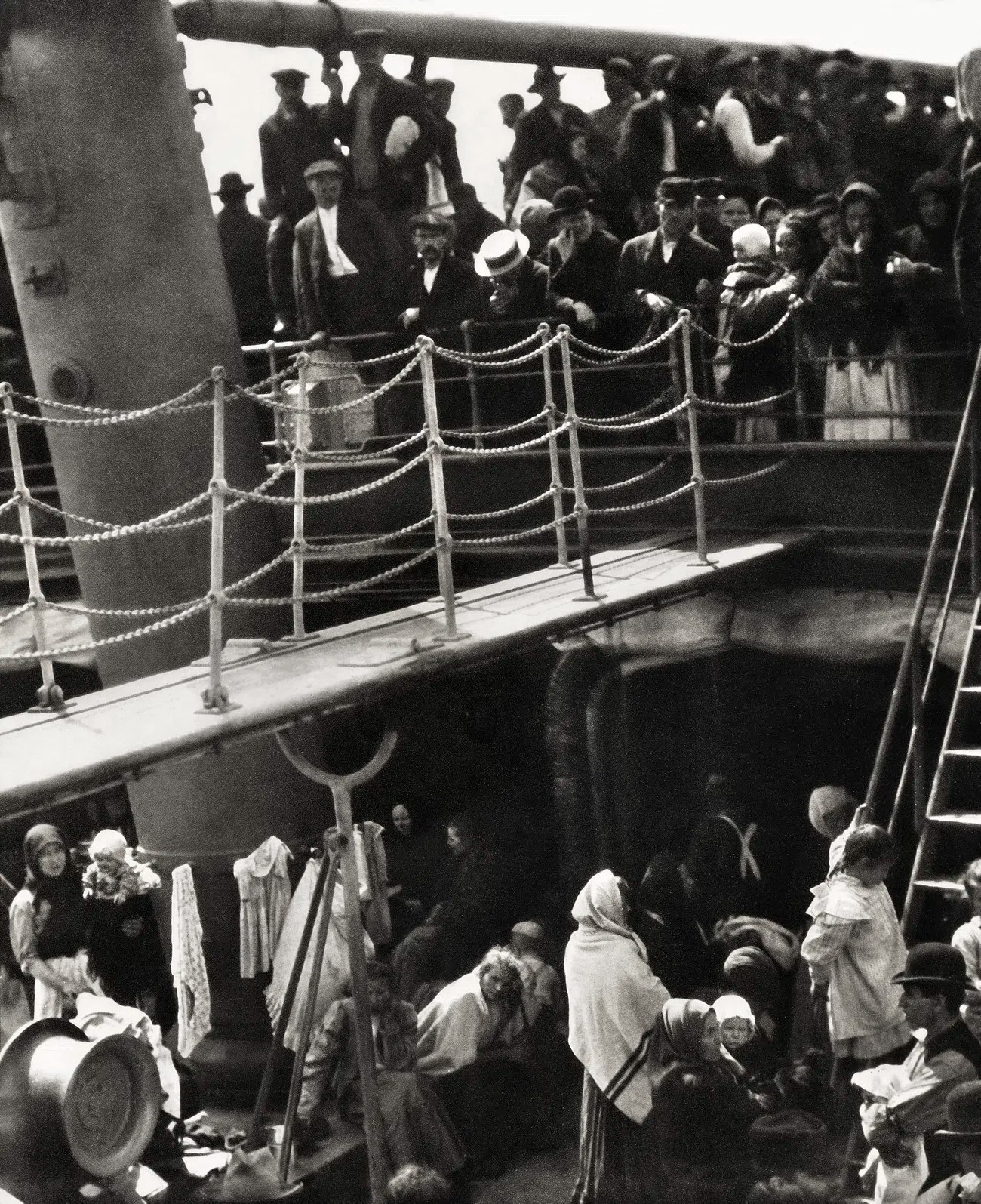 a black and white photograph showing passengers including adults, children and babies travelling steerage on a ship
