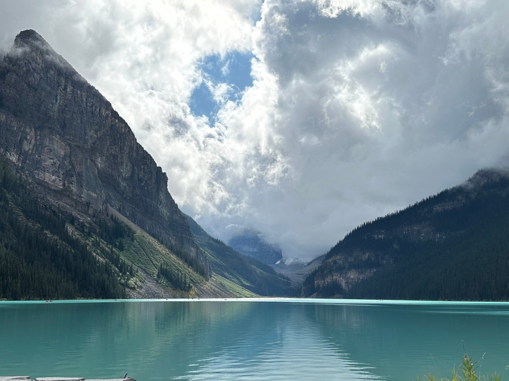 Calm turquoise waters of Lake Louise looking out into the mountains