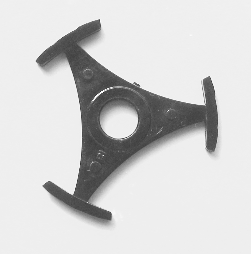 a black plastic adapter to fit in the central hole of an ex-juke box 45rpm single that had the centre removed