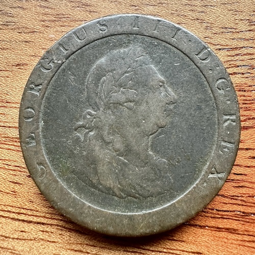 photo of a copper 'cartwheel' penny showing the head of George III