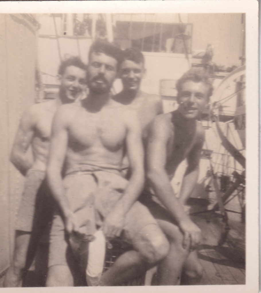 Black and white photograph of a group of young men wearing white shorts aboard HMS Pickle c.1945