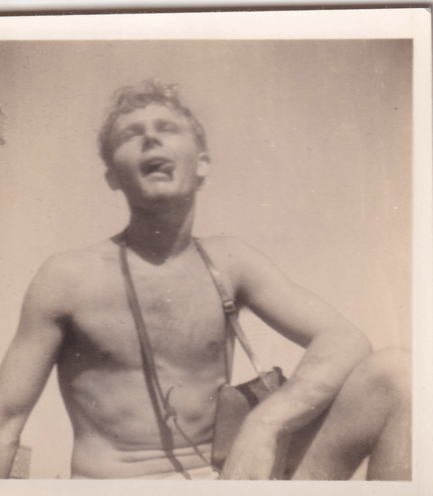 Black and white photograph of a young crew member wearing white shorts aboard HMS Pickle c.1945