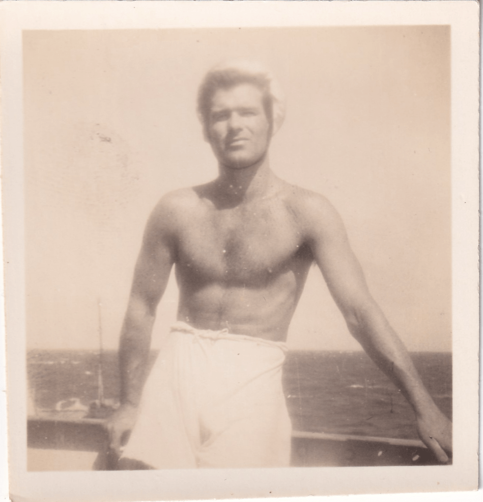 Black and white photograph of a young crew member wearing white shorts aboard HMS Pickle c.1945