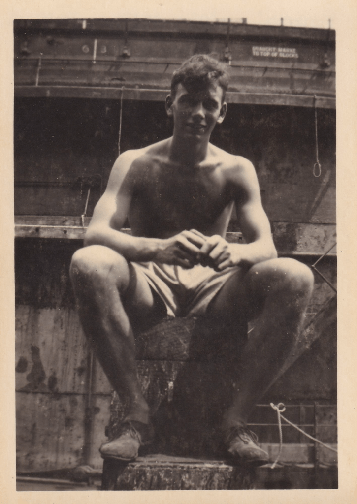 A young men, presumed to be one of the crew of HMS Pickle, sitting on a mooring bollard c.1945