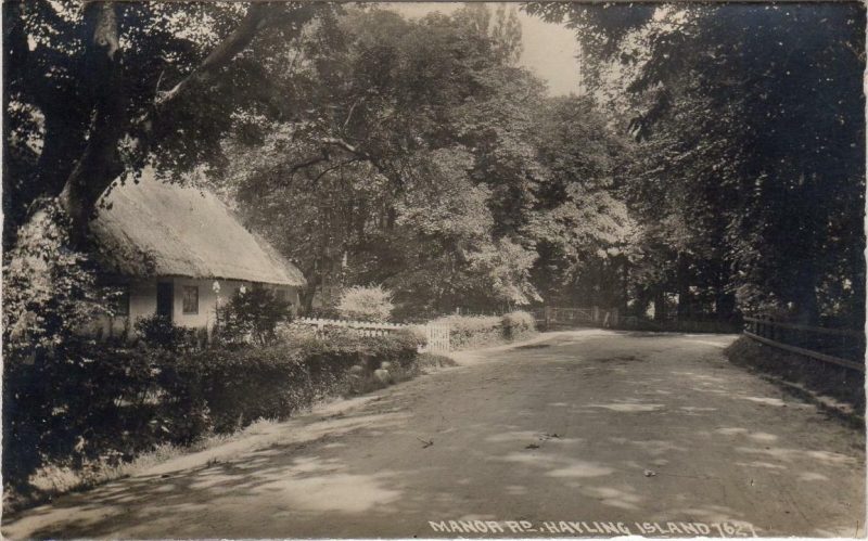Vintage postcard of Manor Road, Hayling Island, featuring a single storey thatched cottage set back off a tree line road.
