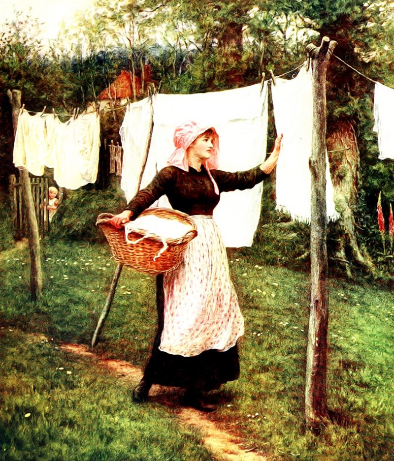 A young woman dressed in historical clothing stands outdoors, hanging freshly washed laundry on a line. She holds a basket filled with linen while a child is seen in the background.